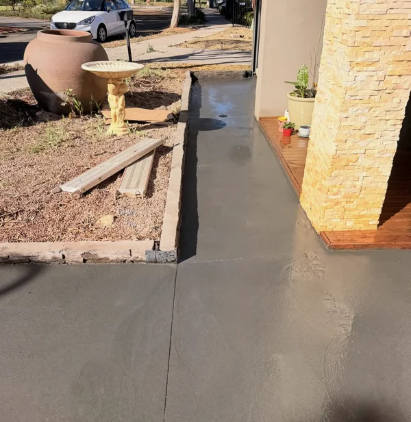 Charcoal concrete path and joints around the entrance at Blakeview